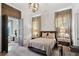 Spacious bedroom with a comfortable bed, nightstands and en-suite bath access at 6870 Colfax Ave, Cumming, GA 30040
