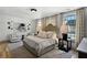 Luxurious Primary bedroom with king bed, sitting area, and artwork at 6870 Colfax Ave, Cumming, GA 30040