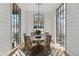 Bright dining room with a round table, wicker chairs, and large windows at 6870 Colfax Ave, Cumming, GA 30040