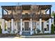 Stunning two-story home with a white exterior, large front porch, and dark brown accents at 6870 Colfax Ave, Cumming, GA 30040