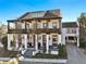 Two-story white home with dark brown accents, balconies, and a covered porch at 6870 Colfax Ave, Cumming, GA 30040