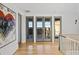 Hardwood floor hallway with French doors opening to a deck with scenic views at 6870 Colfax Ave, Cumming, GA 30040