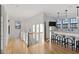 Light-filled hallway with hardwood floors, leading to a wet bar and deck access at 6870 Colfax Ave, Cumming, GA 30040