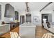 Open kitchen boasts a large island, chevron hardwood floors, and stainless steel appliances at 6870 Colfax Ave, Cumming, GA 30040