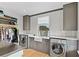 Bright laundry room, features modern gray cabinets, marble countertops, and a farmhouse sink at 6870 Colfax Ave, Cumming, GA 30040
