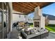 Covered patio with fireplace, seating area, and built-in grill at 6870 Colfax Ave, Cumming, GA 30040