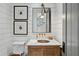 Elegant powder room features a marble vanity, brass fixtures, and shiplap walls at 6870 Colfax Ave, Cumming, GA 30040