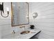 Modern powder room, featuring shiplap walls and a marble floating vanity at 6870 Colfax Ave, Cumming, GA 30040