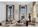 Bright sitting room with large windows, comfortable armchairs, and ottoman at 6870 Colfax Ave, Cumming, GA 30040