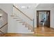 Elegant staircase with light wood and white railings at 6870 Colfax Ave, Cumming, GA 30040