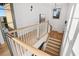 Modern staircase with light wood and white railings, offering a bright and airy feel at 6870 Colfax Ave, Cumming, GA 30040