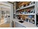 Custom wet bar with quartz countertops and rustic wood shelving at 6870 Colfax Ave, Cumming, GA 30040