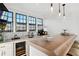 Modern wet bar with white cabinetry, marble countertops, and pendant lighting at 6870 Colfax Ave, Cumming, GA 30040