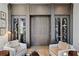 Custom wine room with glass doors, built-in storage and wine racks at 6870 Colfax Ave, Cumming, GA 30040