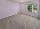 Light purple walls and neutral carpeting in this bedroom at 1043 Carriage Trace Cir, Stone Mountain, GA 30087