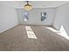Spacious bedroom with plush carpeting, large windows, and a ceiling fan at 1043 Carriage Trace Cir, Stone Mountain, GA 30087