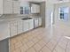 White kitchen cabinets, tile floors, and a breakfast area at 1043 Carriage Trace Cir, Stone Mountain, GA 30087