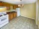 Efficient kitchen with wood cabinets, tiled floor, and white appliances at 1043 Carriage Trace Cir, Stone Mountain, GA 30087