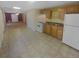 Well-lit kitchen connected to open floor plan with updated appliances and traditional cabinets at 1043 Carriage Trace Cir, Stone Mountain, GA 30087