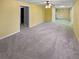 Large living room with carpet, ceiling fan and neutral yellow color scheme at 1043 Carriage Trace Cir, Stone Mountain, GA 30087