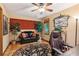 Cozy home office features a leather couch, wood desk, and terracotta tile floors at 5090 Nesbit Ferry Ln, Atlanta, GA 30350