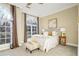 Bright bedroom with large windows, plush bedding, and a cozy sitting area at 1963 Hosea L Williams Se Dr # 205, Atlanta, GA 30317