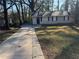 Ranch home with a paved driveway and a grassy yard at 3705 Daisy Dr, Decatur, GA 30032