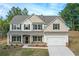 Two-story house with gray roof, beige and white siding, and a two-car garage at 396 Ajo Way, Dallas, GA 30157