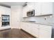 White kitchen with gas range and double ovens at 609 River Hl, Mcdonough, GA 30252