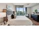 King-size bed, wood floors, and stunning city views from the bedroom at 2795 Peachtree Ne Rd # 703, Atlanta, GA 30305