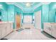 Spa-like bathroom with a soaking tub, double vanity, and turquoise walls at 1561 Annapolis Way, Grayson, GA 30017