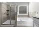 Bathroom featuring a glass enclosed shower, soaking tub, window and granite countertops at 2417 Kingston Heath Way, Marietta, GA 30008