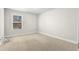 Bright bedroom featuring neutral carpeting and a window at 2417 Kingston Heath Way, Marietta, GA 30008