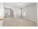 Bedroom featuring neutral carpeting, two windows, and a closet at 2417 Kingston Heath Way, Marietta, GA 30008