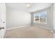 This bedroom features neutral carpeting and a large bright window at 2417 Kingston Heath Way, Marietta, GA 30008