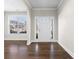 Elegant foyer with hardwood floors, a bright window and a white front door with glass panels at 2417 Kingston Heath Way, Marietta, GA 30008