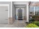 Inviting front porch with gray siding, brick accents and manicured landscaping near the front door at 2417 Kingston Heath Way, Marietta, GA 30008
