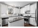 Modern kitchen featuring white cabinets, granite countertops, stainless steel appliances and an island at 2417 Kingston Heath Way, Marietta, GA 30008