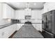 Spacious kitchen with white cabinets, granite countertops, stainless steel appliances and a center island at 2417 Kingston Heath Way, Marietta, GA 30008