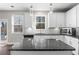 Bright kitchen with white cabinets, granite counters, stainless appliances, and a center island with pendant lighting at 2417 Kingston Heath Way, Marietta, GA 30008