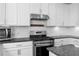 Kitchen features stainless steel appliances, white cabinets, and subway tile backsplash at 2417 Kingston Heath Way, Marietta, GA 30008