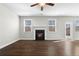 Living room features hardwood floors, a fireplace and a ceiling fan at 2417 Kingston Heath Way, Marietta, GA 30008