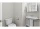 Modern half bathroom featuring a pedestal sink and low flow toilet at 2417 Kingston Heath Way, Marietta, GA 30008