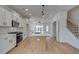 Bright kitchen with hardwood floors, island and white cabinets at 4818 Floydwood Ln, Mableton, GA 30126