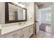 Bathroom with a quartz countertop vanity, framed mirror, and tile floors at 1101 Juniper Ne St # 415, Atlanta, GA 30309