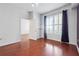 Bedroom features hardwood floors, large window with shutters, and neutral walls at 1101 Juniper Ne St # 415, Atlanta, GA 30309