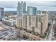 Aerial view showing a large apartment building with a parking lot and greenery at 1101 Juniper Ne St # 415, Atlanta, GA 30309