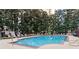 Outdoor swimming pool with lounge chairs surrounded by lush landscaping at a well-maintained property at 1101 Juniper Ne St # 415, Atlanta, GA 30309