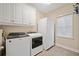 Laundry room with washer, dryer, and cabinets at 2440 Jamerson Rd, Marietta, GA 30066