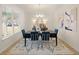 Bright dining room with a table for six and large windows at 3103 Steinbeck Way, East Point, GA 30344